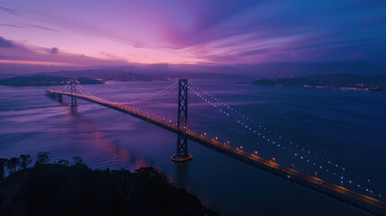 Fototapeta premium Aerial view of a vast bridge spanning a bay at twilight