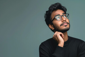 Fototapeta premium an Indian man looking thoughtful on a studio background