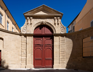 Aix-En-Provence, France - 04 20 2023: View of a typical carved stone portal and wooden door in...