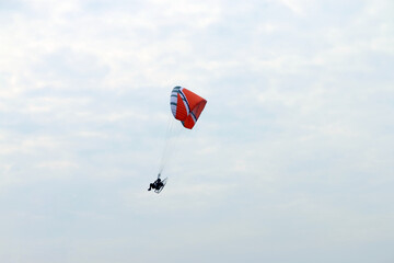Paramotor vehicle flying over  blue sky, Powered paraglider