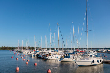 Marina sea port, sailboats moored at the dock and reflected in the sea, harbor, sea and blue sky,...