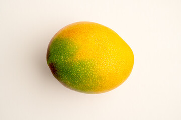 whole mango lying on a white background