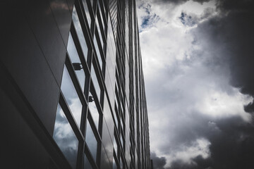 Low angle view of a modern building against cloudy sky