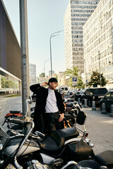 A stylish young man with red hair standing by a row of parked motorcycles in the city.