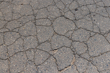 a part of a highway covered with cracked asphalt