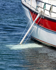 Fishing boat with an aluminium stabilizer deployed.