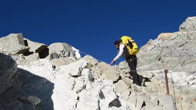 Young caucasian woman trekker struggle from altitude sickness on trekking to Gokyo ri village. Cho la pass top viewpoint