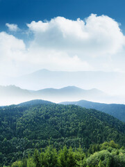 blue sky and cloud above mountains in aerial summer landscape