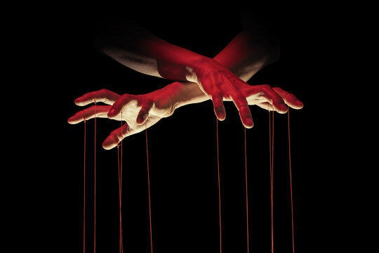 Puppeteer's hands with strings on each finger on black background.