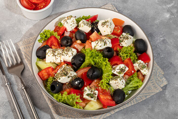 Salad with olives and cucumbers, tomatoes, cheese and sauce. Boiled egg.
