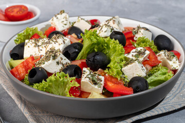 Salad with olives and cucumbers, tomatoes, cheese and sauce. Boiled egg.