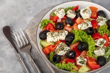 Salad with olives and cucumbers, tomatoes, cheese and sauce. Boiled egg.