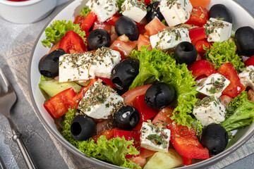 Salad with olives and cucumbers, tomatoes, cheese and sauce. Boiled egg.