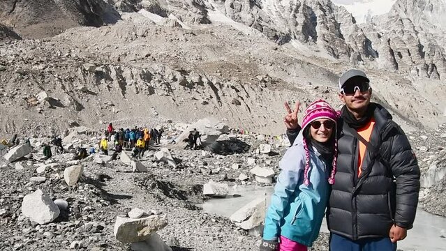 Young male nepalese guide with client caucasian european trekker by Everest base camp in Nepal. EBC alpine trekking outdoors in Himalayas mountains.Safety and guidance in Napal