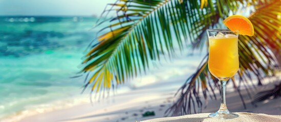 Obraz premium Refreshing cocktail on a tropical beach with palm trees and white sand. Concept of summer sea vacation and travel with room for text.