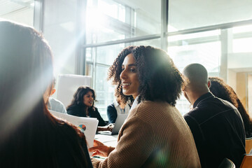 Businesswoman collaborating with diverse team during a business meeting