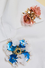 Two decorative handmade brooches on a white shirt