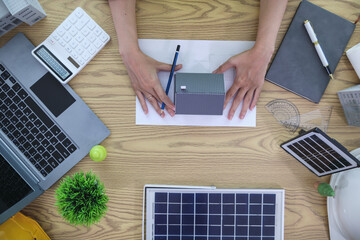 Engineers are reviewing plans from architects to prepare to install solar panels and wind turbines...