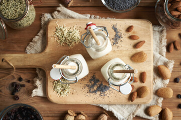 Vegan nut milks made of hemp seeds, poppy seeds and almonds with recyclable paper straws