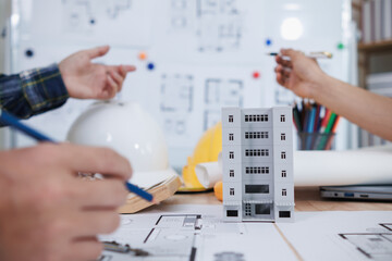 engineering is currently discussing structural design issues with architects to review plans to suit construction and stability of building. concept joint consultation between engineers and architects