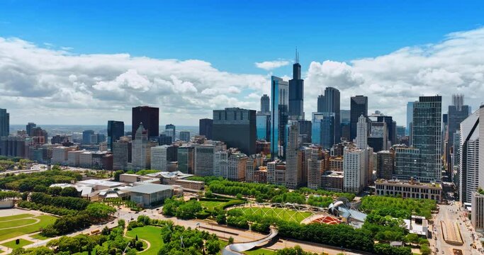 Beautiful green park surrounded by modern high-rise architecture. Millennium Park in Chicago, Illinois, United States. Aerial view.