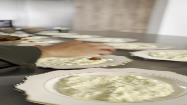Preparing stracciatella di bufala with roasted tomatoes and bacon flambe 