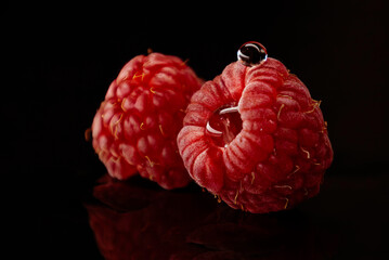 Water drops on Raspberry isolated with black background