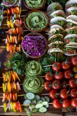 Fototapeta premium Elegant Raw Food Appetizer Platter with Mini Raw Tacos and Vegetable Skewers for High-end Events