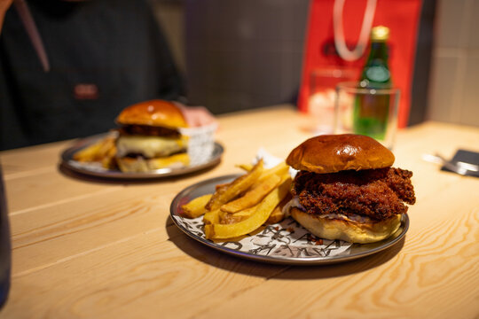 Various burgers and fries served on stylish plates in a restaurant