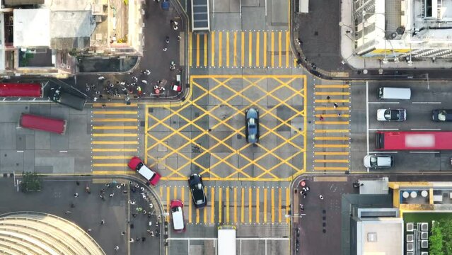 Car traffic transport on road, pedestrian people walk cross zebra crossing, crossroad junction in Mong Kok, Hong Kong downtown. Drone aerial top view. Asian lifestyle, Asia transportation city life