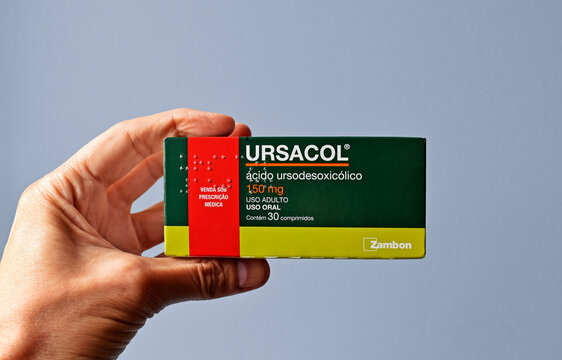 RIO DE JANEIRO, BRAZIL - APRIL 21, 2022: Hand holding a box of ursodeoxycholic acid pills