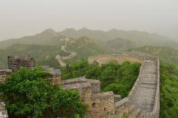 The majestic Great Wall of China in the Chinese mountains north of Beijing in the evening with a...