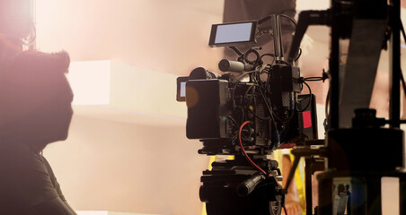 Filmmaker crew team with professional cinema equipment and video camera on the set. Film director and crew making commercial content advertising in studio. Technique of modern filming and advertising.