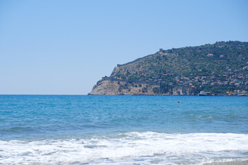 Naklejka premium Mediterranean seaside coast in calm weather on blue sky background.