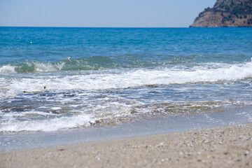 Mediterranean seaside coast in calm weather on blue sky background.