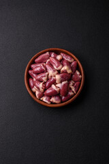 Raw chicken hearts with salt, spices and herbs
