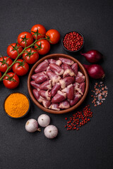 Raw chicken hearts with salt, spices and herbs