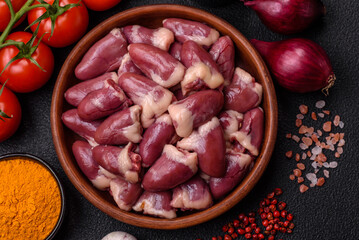 Raw chicken hearts with salt, spices and herbs