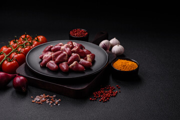 Raw chicken hearts with salt, spices and herbs