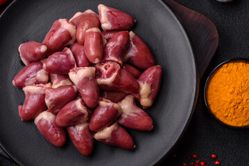 Raw chicken hearts with salt, spices and herbs