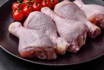 Raw chicken legs with salt, spices and herbs