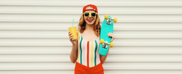 Summer portrait of happy cheerful stylish young woman with skateboard posing in colorful clothes © rohappy
