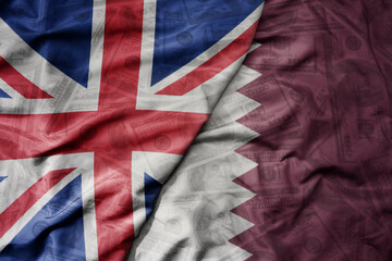 big waving colorful flag of qatar and national flag of great britain on the dollar money...
