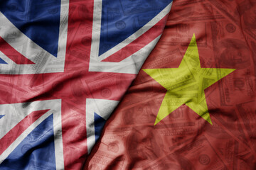 big waving colorful flag of vietnam and national flag of great britain on the dollar money background. finance concept.