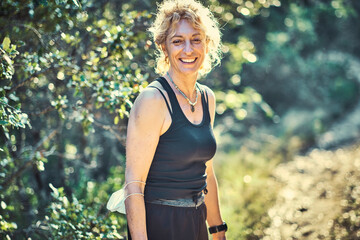 Fototapeta premium A woman with blonde hair is smiling in a forest.