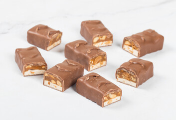 Energy Candy bar. Nougat, caramel with peanuts, in milk chocolate. In the section. White background. 