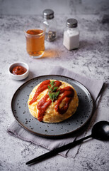 Omurice with ketchup sauce in a plate