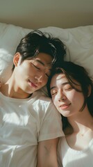 Asian couple waking up on a bed
