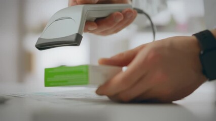 Medicine. A pharmacist uses an electronic scanner to dispense medications at a pharmacy. In slow motion, a young fair-skinned man works at a pharmacy counter, demonstrating professional skills