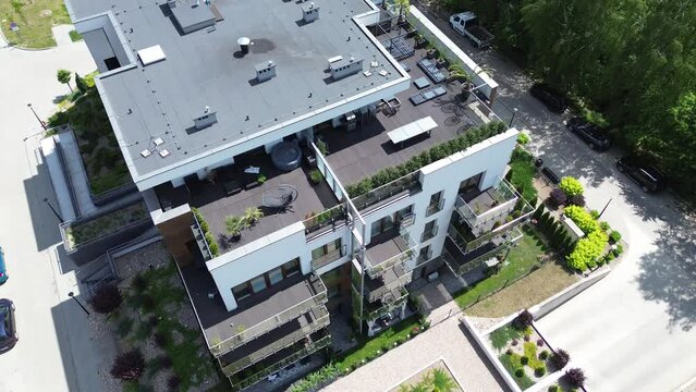 Modern apartment building with rooftop terraces and green gardens